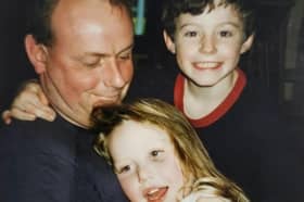A photo of Stevan McIntosh, with his children Catrina McIntosh and Sean McIntosh In the 1990s.