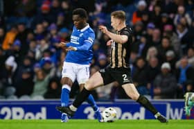 Rabbi Matondo (L) and Annan's Scott Hooper in action during a Scottish Gas Scottish Cup Fourth Round match between Rangers and Annan Athletic