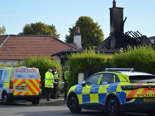 Police remain at the property over 48hrs after the blaze tore through the bungalow  
