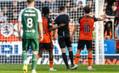Referee Don Robertson initially awards a penalty before a VAR check overturns it during a William Hill Premiership match between Dundee United and Hibernian at Tannadice