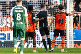 Referee Don Robertson initially awards a penalty before a VAR check overturns it during a William Hill Premiership match between Dundee United and Hibernian at Tannadice