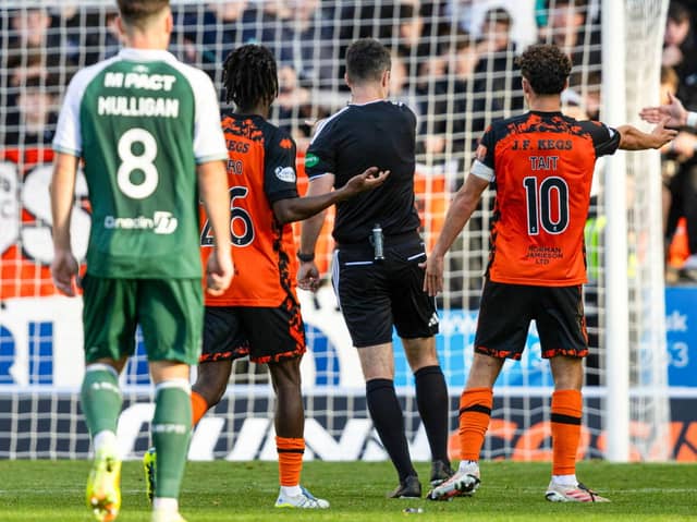 Referee Don Robertson initially awards a penalty before a VAR check overturns it during a William Hill Premiership match between Dundee United and Hibernian at Tannadice