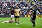 St Mirren's Alex Gogic (C) is shown a yellow card by Referee Nick Walsh as he fouls Hearts' Josh McPake inside the box conceding a penalty 