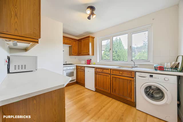 A modern fitted kitchen with wall and base units provides useful storage and a dedicated space for everyday cooking