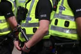 A row of Police Scotland officers in high-vis jackets