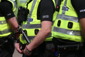 A row of Police Scotland officers in high-vis jackets