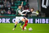 Hibernian's Jamie McGrath and Falkirk's Connor Allan in action 
