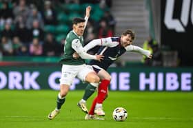 Hibernian's Jamie McGrath and Falkirk's Connor Allan in action 