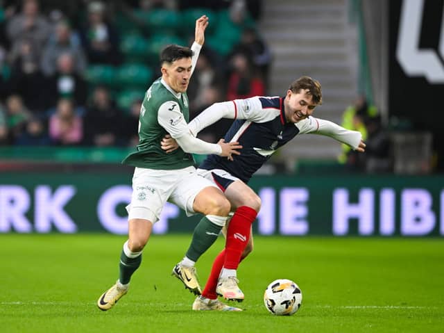 Hibernian's Jamie McGrath and Falkirk's Connor Allan in action 