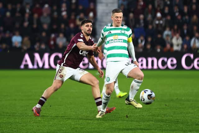 Claudio Braga of Hearts and Callum McGregor of Celtic tussle for possession during a Premiership clash in January 2026