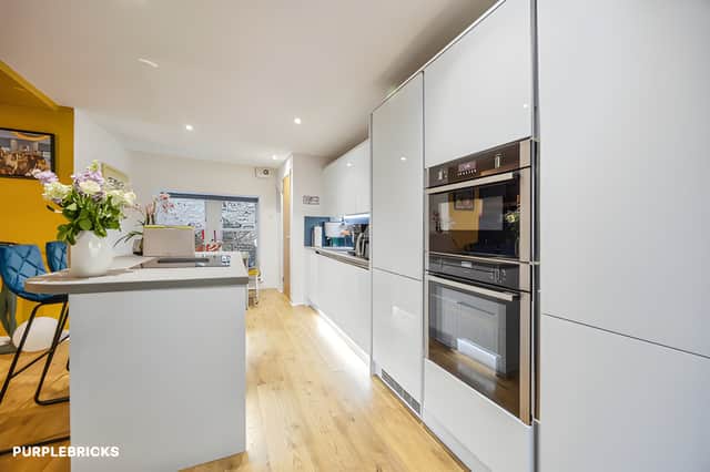 The modern kitchen provides a practical space for everyday cooking, complementing the flat's move-in-ready presentation.