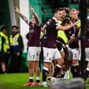Hearts' Calvin Miller (L) and teammates celebrate as Josh McPake scores to make it 3-1 during a William Hill Premiership match between Hibernian and Heart of Midlothian