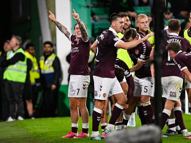 Hearts' Calvin Miller (L) and teammates celebrate as Josh McPake scores to make it 3-1 during a William Hill Premiership match between Hibernian and Heart of Midlothian