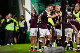 Hearts' Calvin Miller (L) and teammates celebrate as Josh McPake scores to make it 3-1 during a William Hill Premiership match between Hibernian and Heart of Midlothian