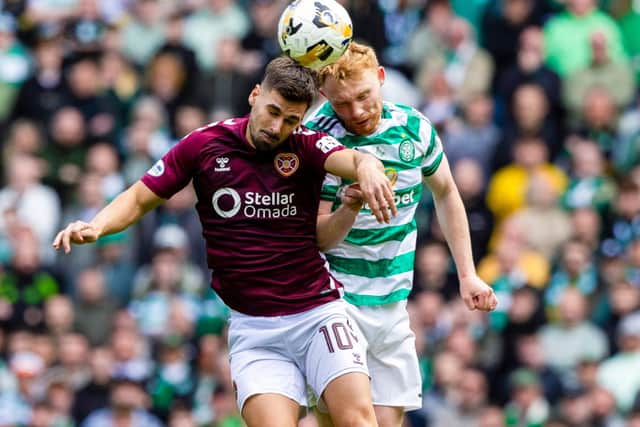 Celtic's Liam Scales and Hearts' Claudio Braga in action