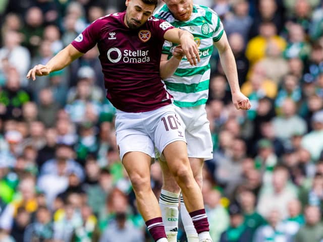Celtic's Liam Scales and Hearts' Claudio Braga in action 