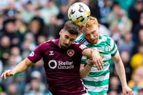 Celtic's Liam Scales and Hearts' Claudio Braga in action 