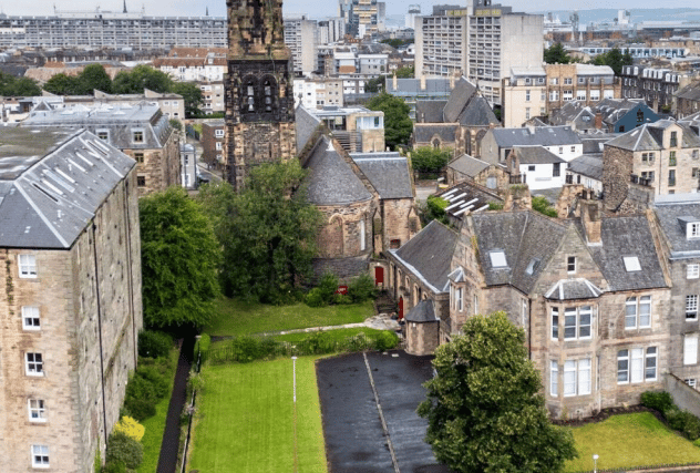 The office building on the right would house the four flats, while the adjacent vacant land would become a car park and four separate gardens.
