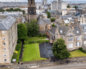 The office building on the right would house the four flats, while the adjacent vacant land would become a car park and four separate gardens.
