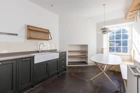The spacious fitted kitchen / dining room with wall and base units and integrated appliances.