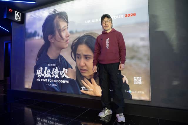 Don Ng, the director and screenwriter of NO TIME FOR GOODBYE, poses with the movie's poster at Cineworld cinema in Edinburgh.
