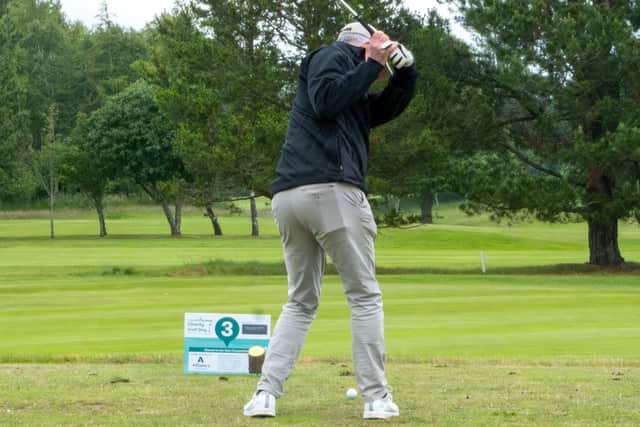 Golfer teeing off at annual golf event