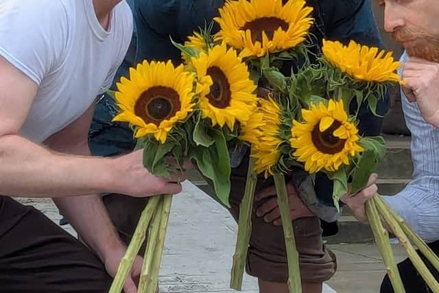 L-R Joe Coffey, Donna Oblongata and Murray Andrews with sunflowers