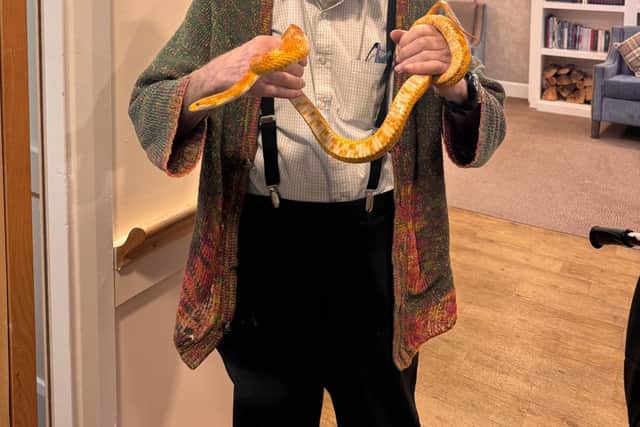 Resident Dr Martin Meyers holding a snake