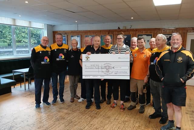 Holding the cheque is Adrian Fisher (President Midlothian Walking Rugby) and Sophie Johnston (Senior Care Support Practitioner – VOCAL)