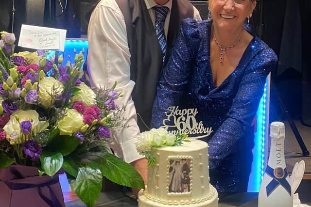 Celebrating 60 years of Marriage, Ronnie and Rosalind cut the cake at their special celebration