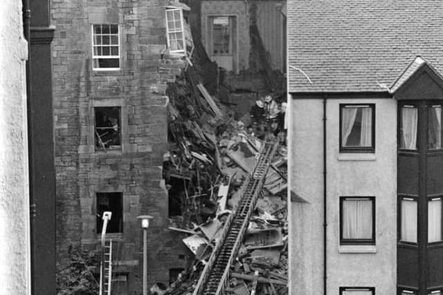 Wreckage of the blast. The fireman in a light-coloured jacket at the top of the ladder is Colin Foster, who used thermal imaging to search the rubble.