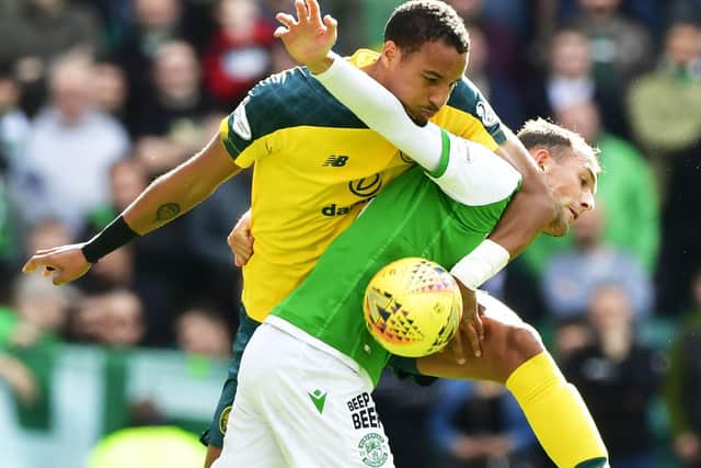 Christian Doidge shows the determination of the Hibs side in this challenge by Christopher Jullien