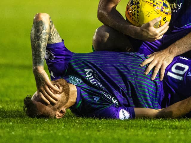 Hibs winger Martin Boyle lies in agony having suffered a recurrence of a knee injury which forced him into a second operation this year. Pic: SNS