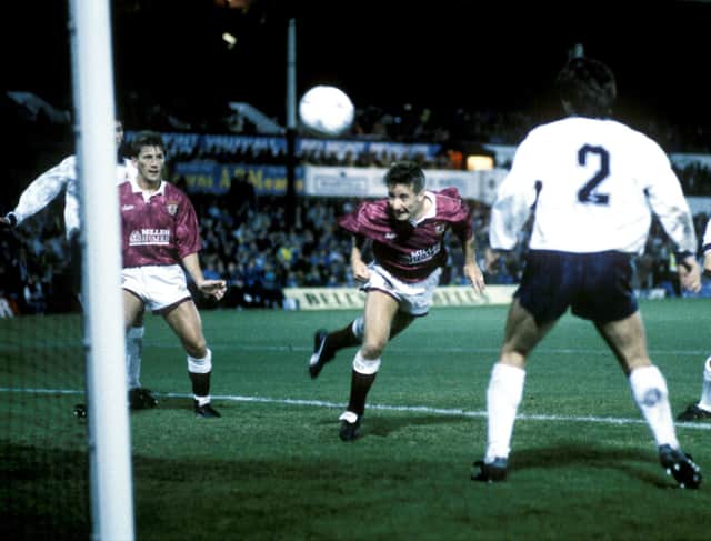 John Robertson (centre) heads home his second goal of the game for Hearts