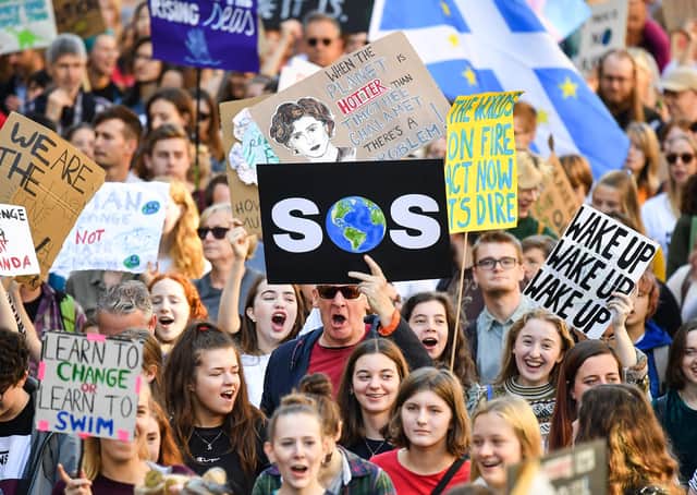 Protesters march and hold placards as they last month's climate strike in Edinburgh. Picture: Getty