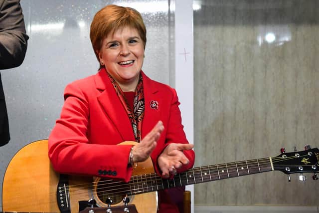 A small crowd gathered to listen to the First Minister's rendition of the Monkees classic. Picture: AFP/Getty Images