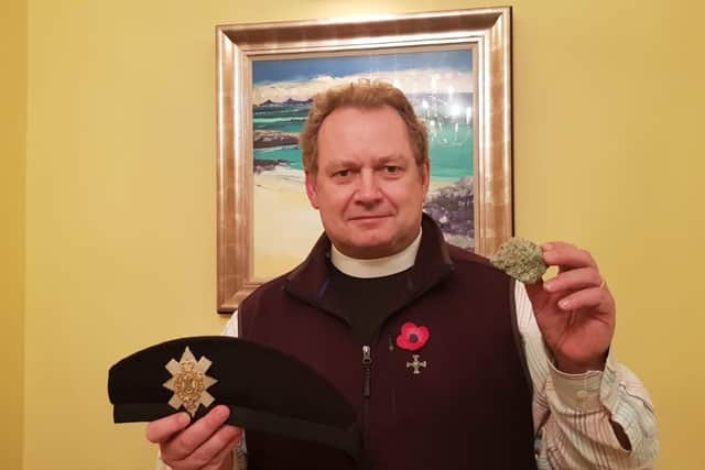 Peter Sutton with his Black Watch cap and a piece of the Berlin Wall. Picture: Church of Scotland.
