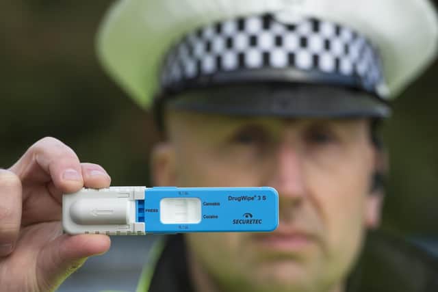 PC Stewart Logan holding one of the Drugswipe testing kits. Picture: Neil Hanna.