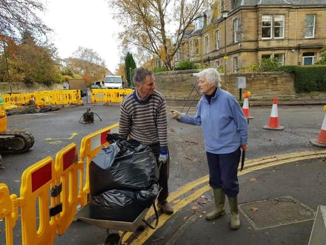 Grange members Richard Doake and Nicola Crosbie wheelbarrow leaves in 2018