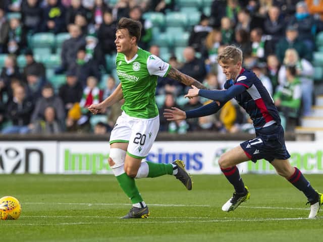 Melker Hallberg tries to scape the attentions of Ross Countys Ewan Henderson at Easter Road