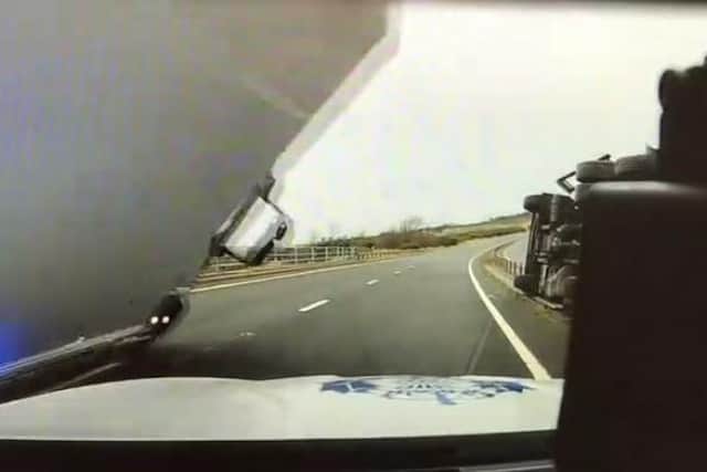 New police dash-cam footage shows the moment before the toppling lorry lands on the patrol car. Pic: Police Scotland.
