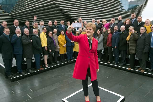 Nicola Sturgeon takes a selfie with the SNP’s newly-elected MPs at the V&A in Dundee. (Picture: AFP/Getty)