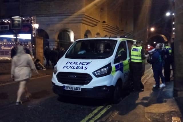 Police and Street Assist help a reveller in the Cowgate