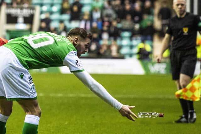 Martin Boyle throws a bottle from the pitch during Hibs tie with Rangers