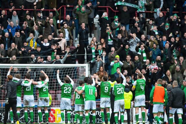 Hibs players celebrate with fans at full-time. Picture: SNS