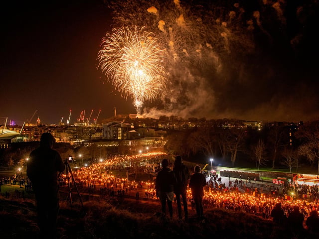 Crowds gathered to create a symbol of friendship against the backdrop of the city centre before a fireworks display above Calton Hill. Pic: Ian Georgeson