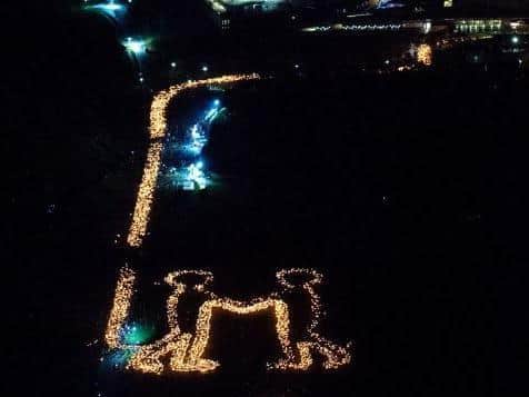 An estimated 40,000 people turned out for the Torchlight Procession which led a sea of lights from the Royal Mile down to Holyrood Park, where an image of two people shaking hands was created to symbolise togetherness.