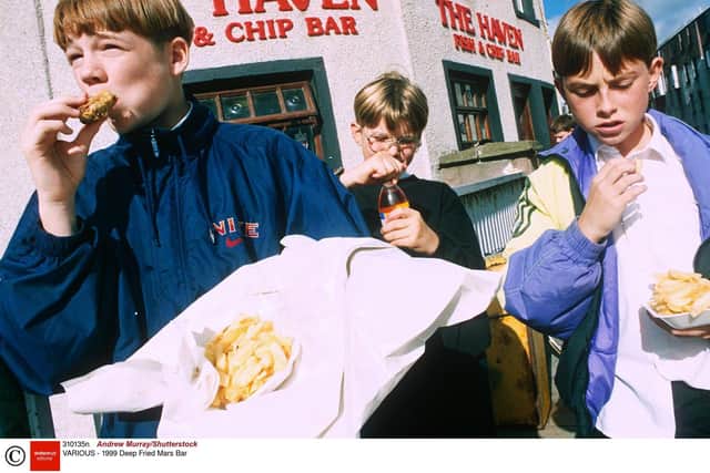 Children enjoy deep fried Mars Bars at the Carron Fish Bar (known back in 1995 as The Haven.