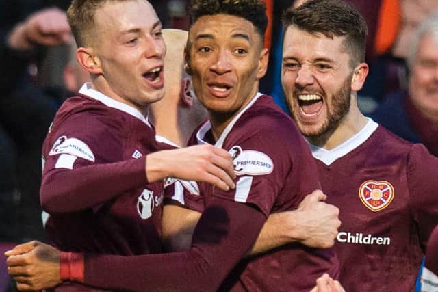 Lewis Moore, Sean Clare and Craig Halkett mob Steven Naismith after Hearts equalise against Rangers. Picture: SNS