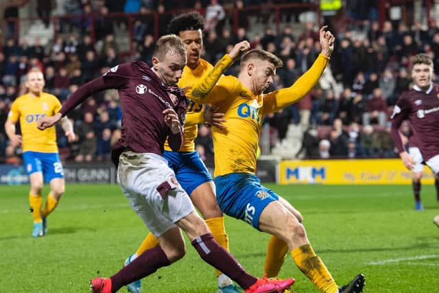 Lewis Moore battles for possession with Stuart Findlay. Picture: SNS